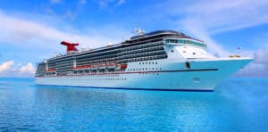 A large cruise ship is docked in the ocean.